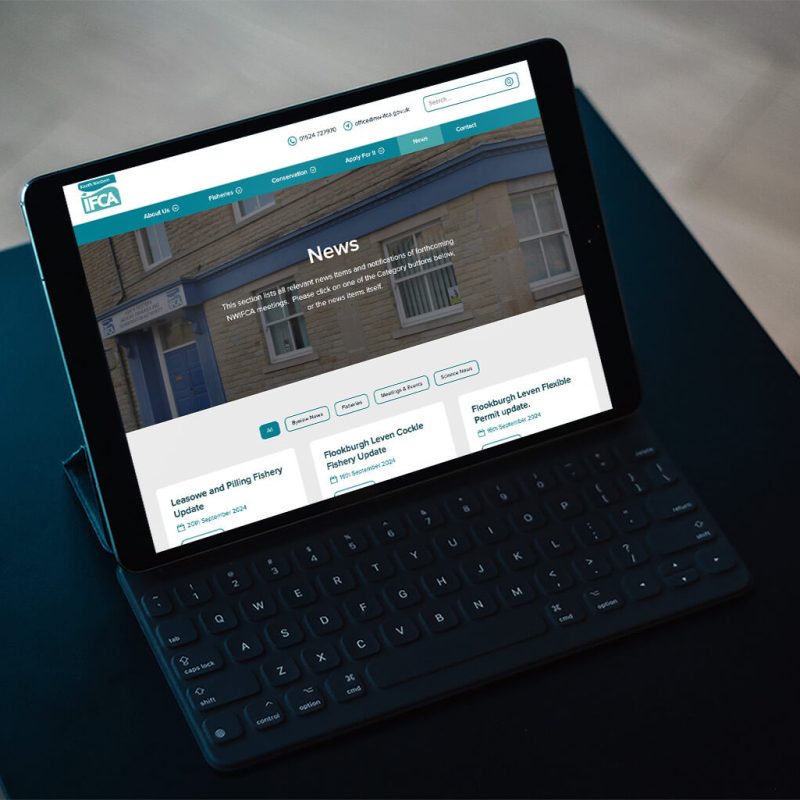 Custom News section displayed on a laptop