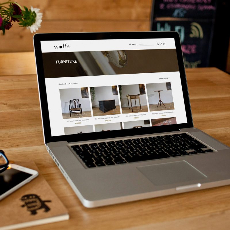 wolfe curated website on a laptop screen